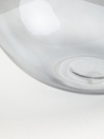 Clear glass vase with smooth curved rim and subtle concentric patterns near base from bree grey glass collection