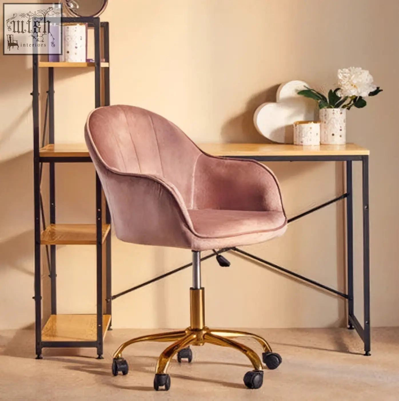 A plush dusty rose pink velvet office chair with a gold-tone base and casters perfect for your home office