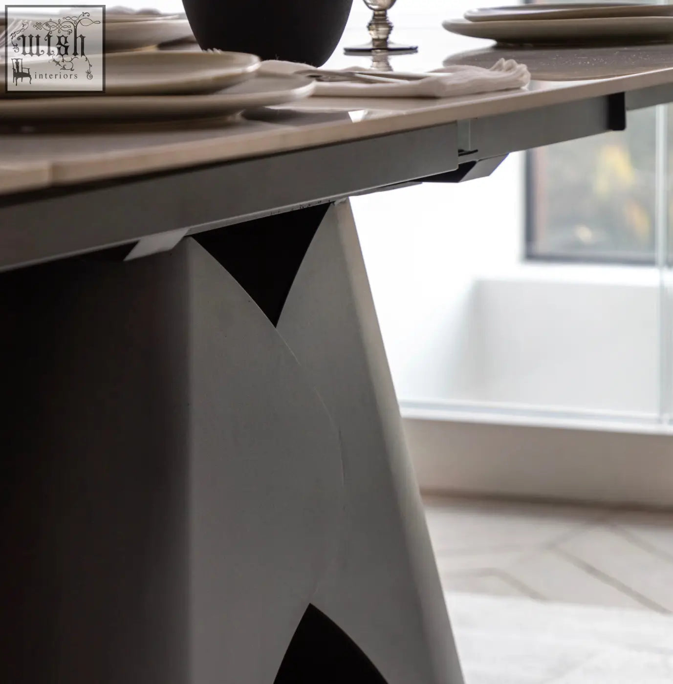 Modern brezzo extendable dining table with sleek geometric base in bold black and white marble style ceramic