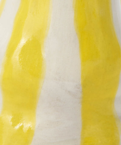 Bright yellow candy stripe candle holder with glossy yellow and white striped fabric and a wavy texture