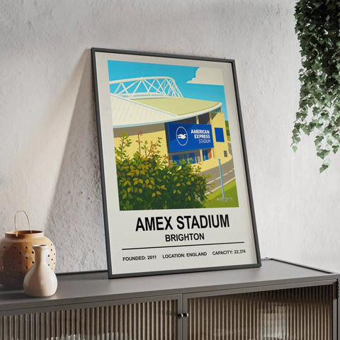 A framed Brighton amex stadium print featuring a stylized blue and yellow illustration on white background