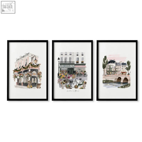 Set of three black framed british posters featuring pastel london cityscape travel wall art prints with floral scenes