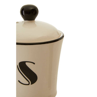 Cream-colored ceramic broadway sugar canister with black lid and bold black s monogram for storing sugar