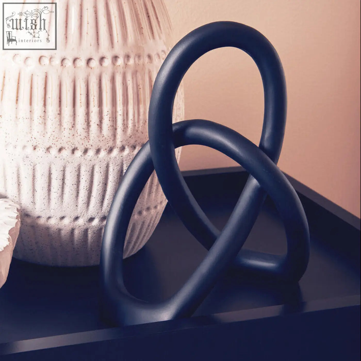 Dark blue ceramic broc black knot sculpture with interlocking loops as a stylish black knot sculpture decor