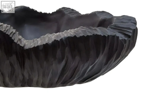Dark gray hand-carved stone curved textured black bowl with leaf-like rim and vertical ridges perfect for serving