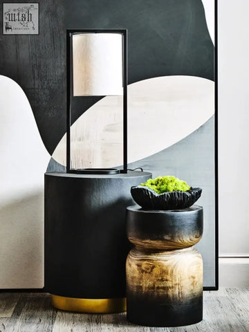 Black and gold curved textured black cylindrical side table with a matte finish and textured black bowl design