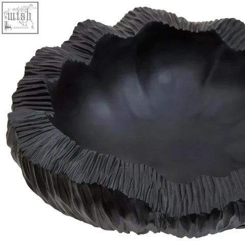 Curved textured black bowl with ridged organic edge and smooth interior perfect for serving or decor