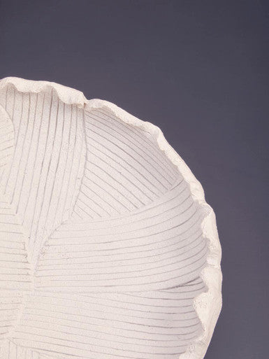 White textured bowl with scalloped rim and fine vertical ridges made of ceramic for stylish serving