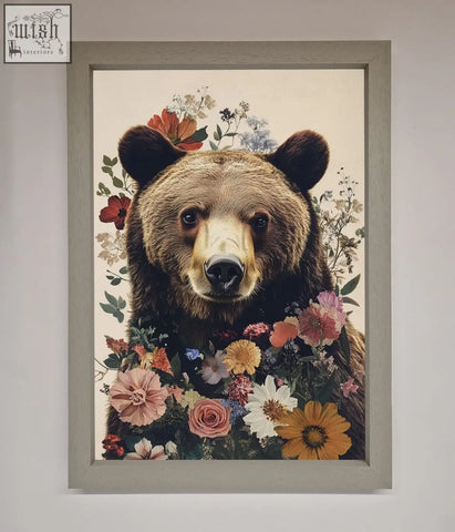 A brown grizzly bear floral framed print with colorful flowers in a light gray wooden frame