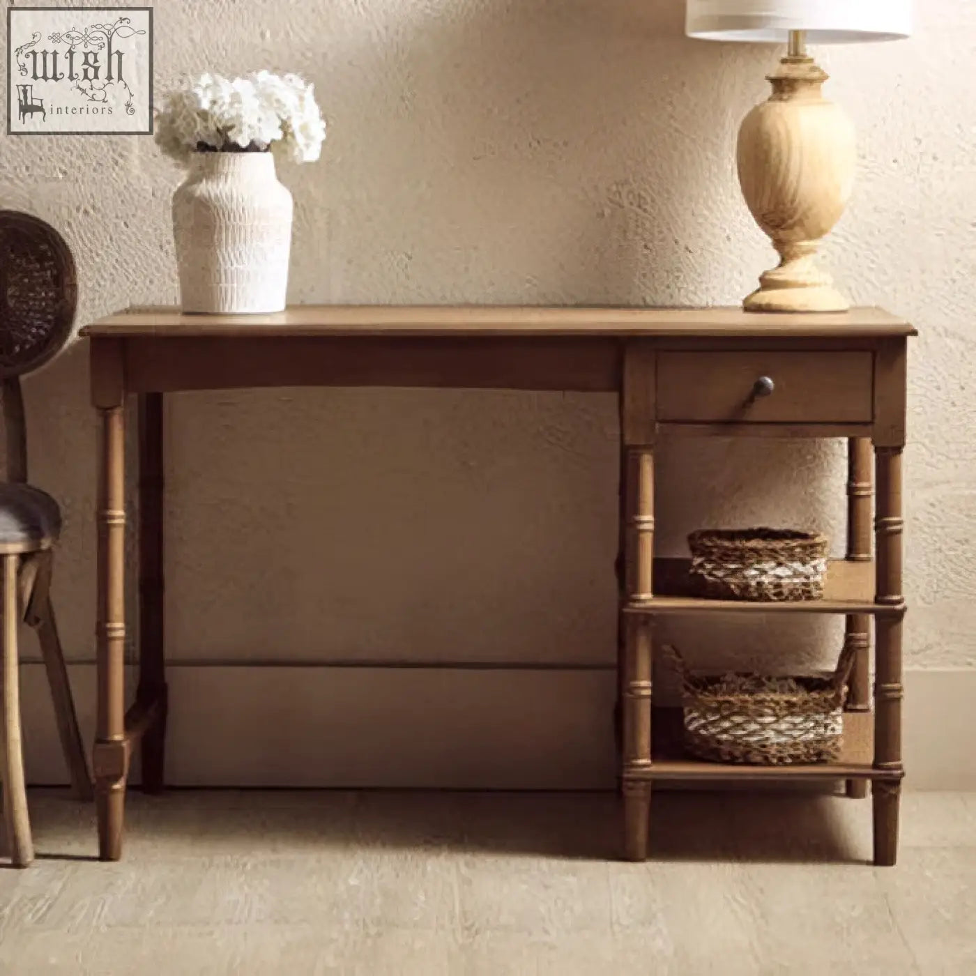 Brown pine wood console table with one drawer and two shelves holding woven baskets for storage and decor