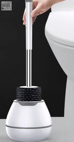 White ceramic toilet brush holder with sleek silver handle and black bristles for bathroom household use