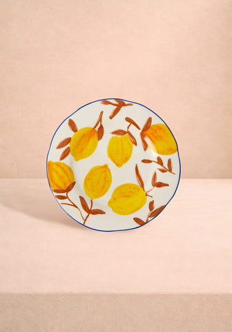 A set of 4 hand-painted white ceramic lunch plates with yellow lemon patterns and blue rims inspired by Matisse