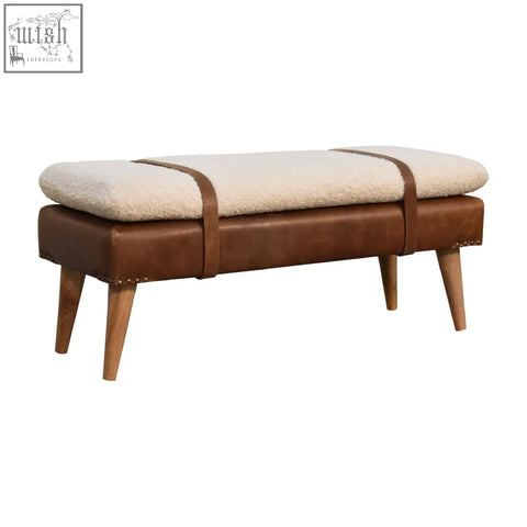 Brown buffalo hide leather bench with cream sheepskin upholstery and wooden legs for cozy seating
