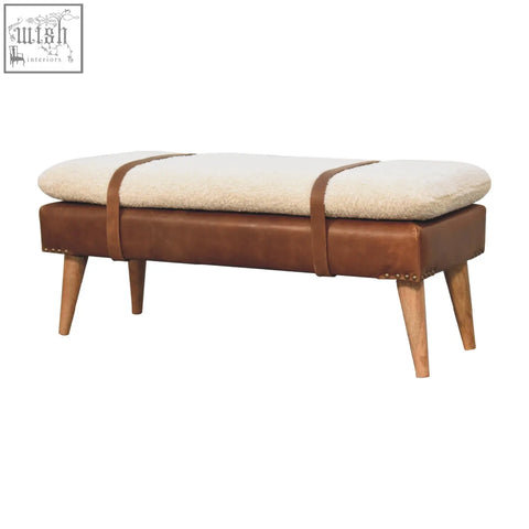 Brown buffalo hide leather bench with cream sheepskin cushion and wooden legs for cozy seating