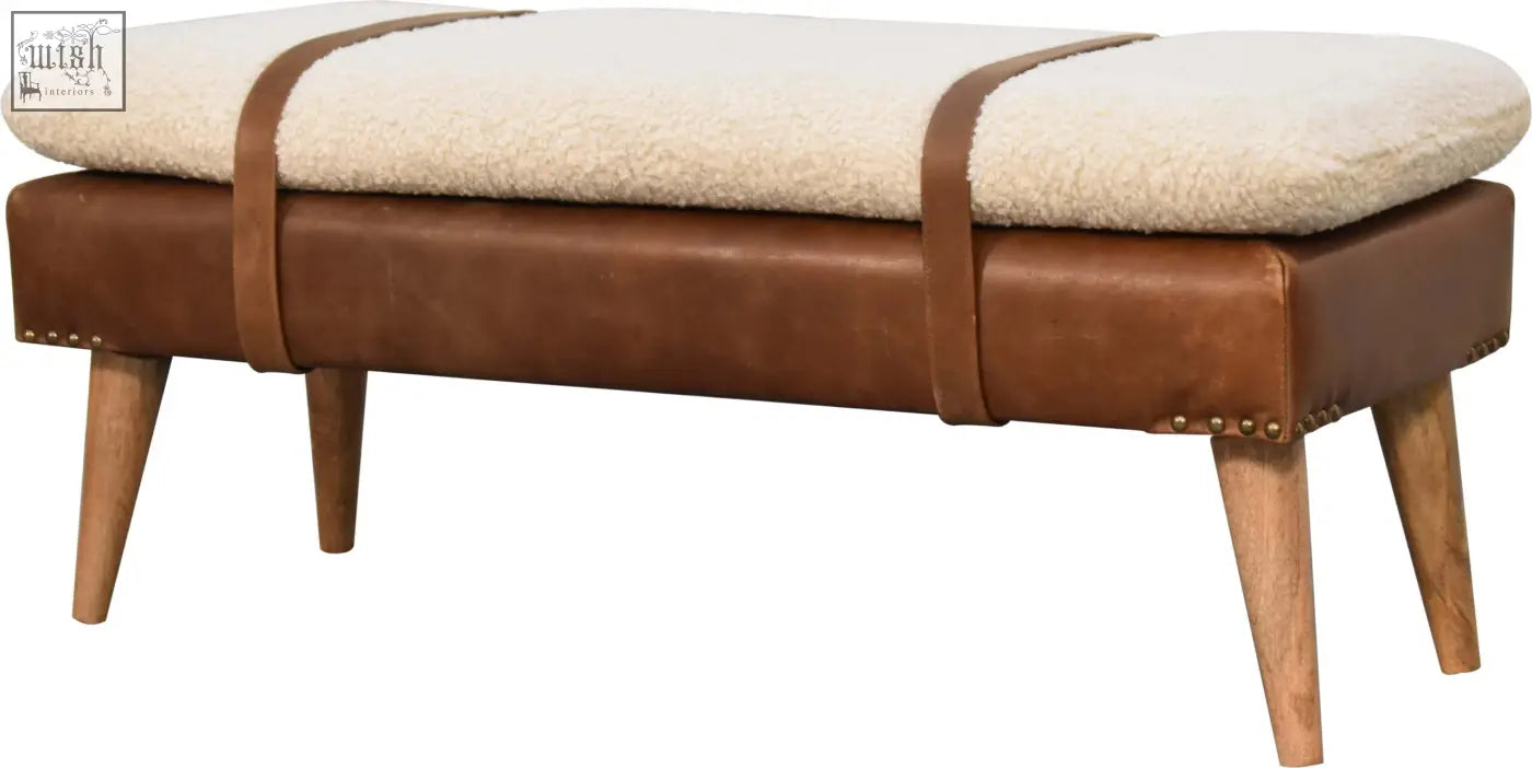 Brown buffalo hide leather bench with cream sheepskin cushion and wooden legs for cozy seating