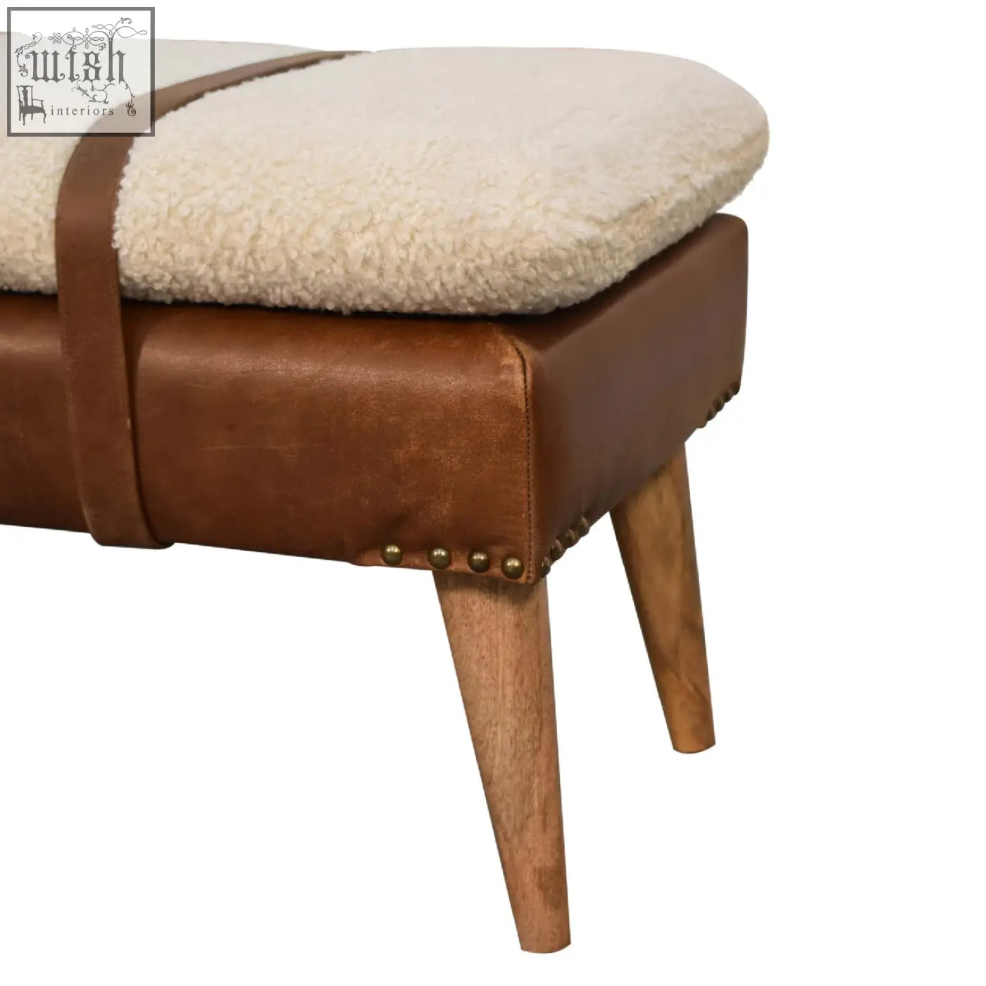 Cream-colored sheepskin cushioned buffalo hide leather bench with brown leather frame and wooden legs