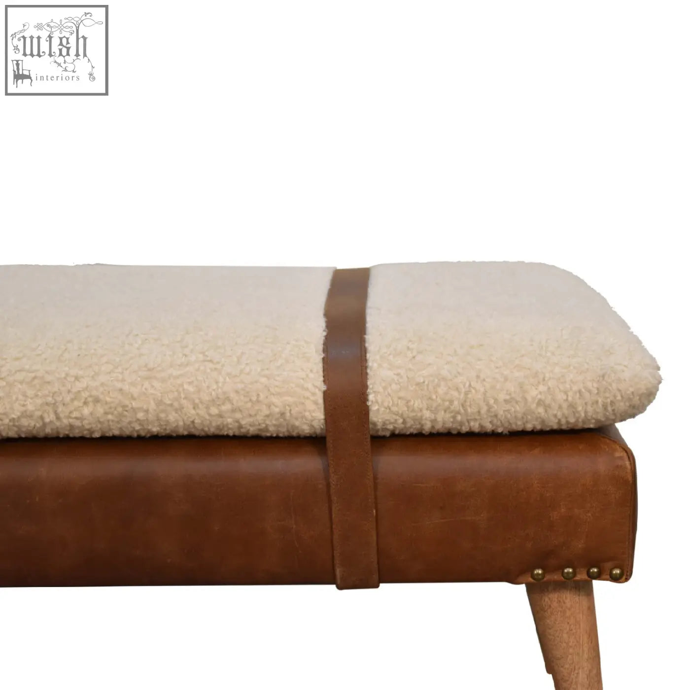 Cream-colored sheepskin cushioned bench with a brown buffalo hide leather frame and matching strap