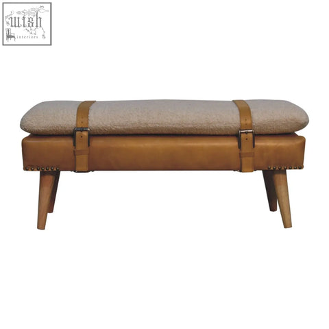 Tan leather bench with beige textured cushion and wooden legs inspired by buffalo hide olive green style