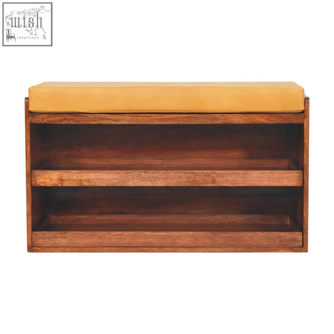 A mustard-yellow upholstered shoe storage bench with three shelves made of solid mango wood for organized shoe storage