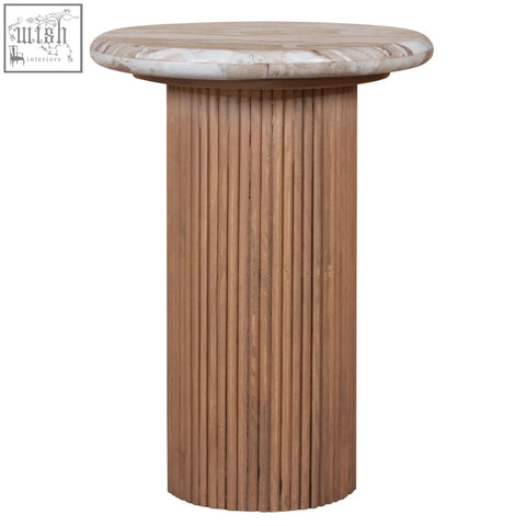 A sleek pedestal side table with a light beige natural marble top and fluted mango wood base
