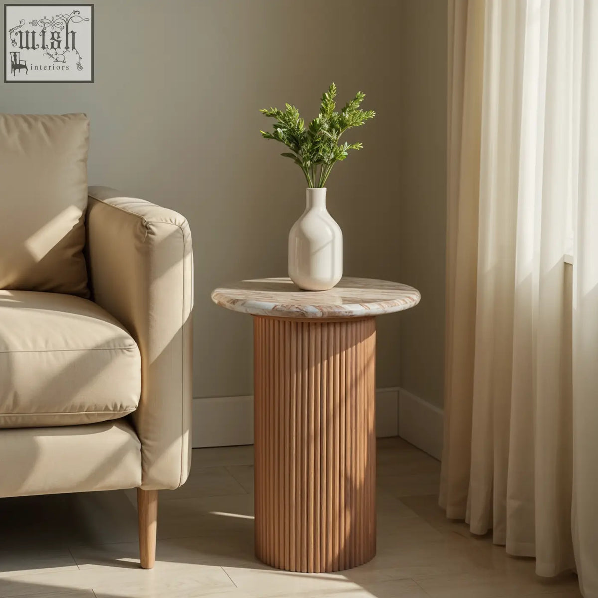 A bundi pedestal side table with a natural marble top and fluted mango wood base holding a white ceramic vase