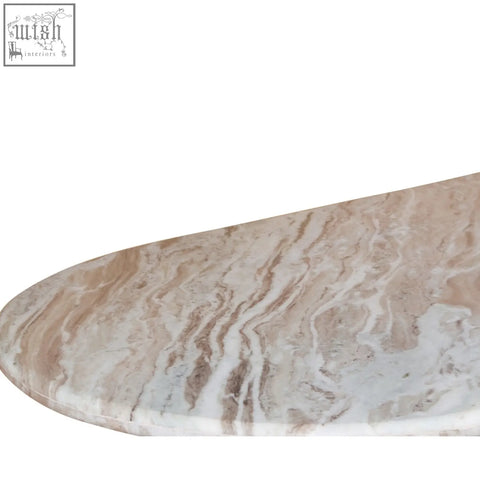 A sleek natural marble oval tabletop with beige and soft brown veining on the bundi mango wood pedestal side table