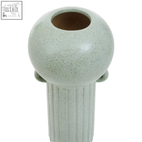 A calcita large speckled green ceramic vase with a matte finish and vertical ridged columns on a rounded top