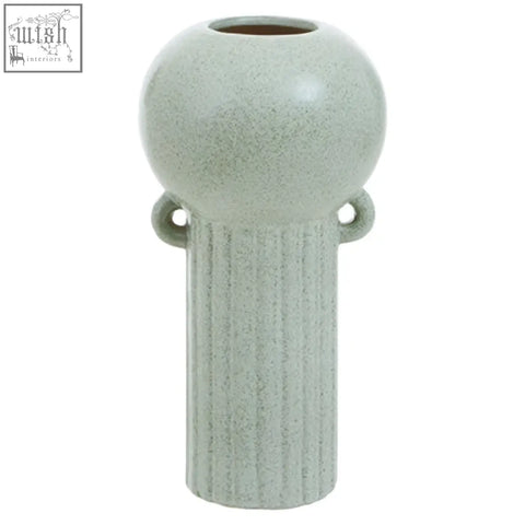 A matte-finished calcita large speckled green ceramic vase with a rounded top and vertical ribbed body