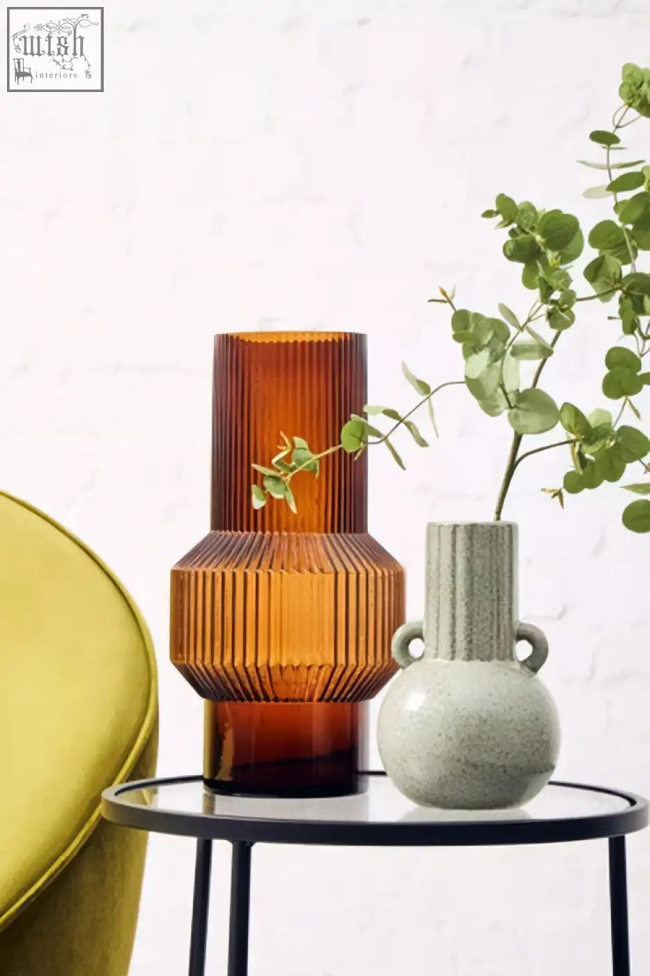 Amber-colored ribbed glass vase with a flared top and rounded base for the calcita small speckled green collection