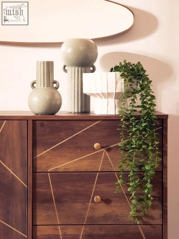 Two textured ceramic vases featuring the calcita small speckled green vase and a grooved design on a wooden dresser