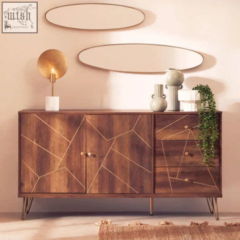 Wooden sideboard with geometric gold inlay and slender metal legs beside a calcita small speckled green vase