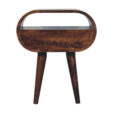 A sleek oval california walnut circular bedside table with open slot and rich brown wood grain finish
