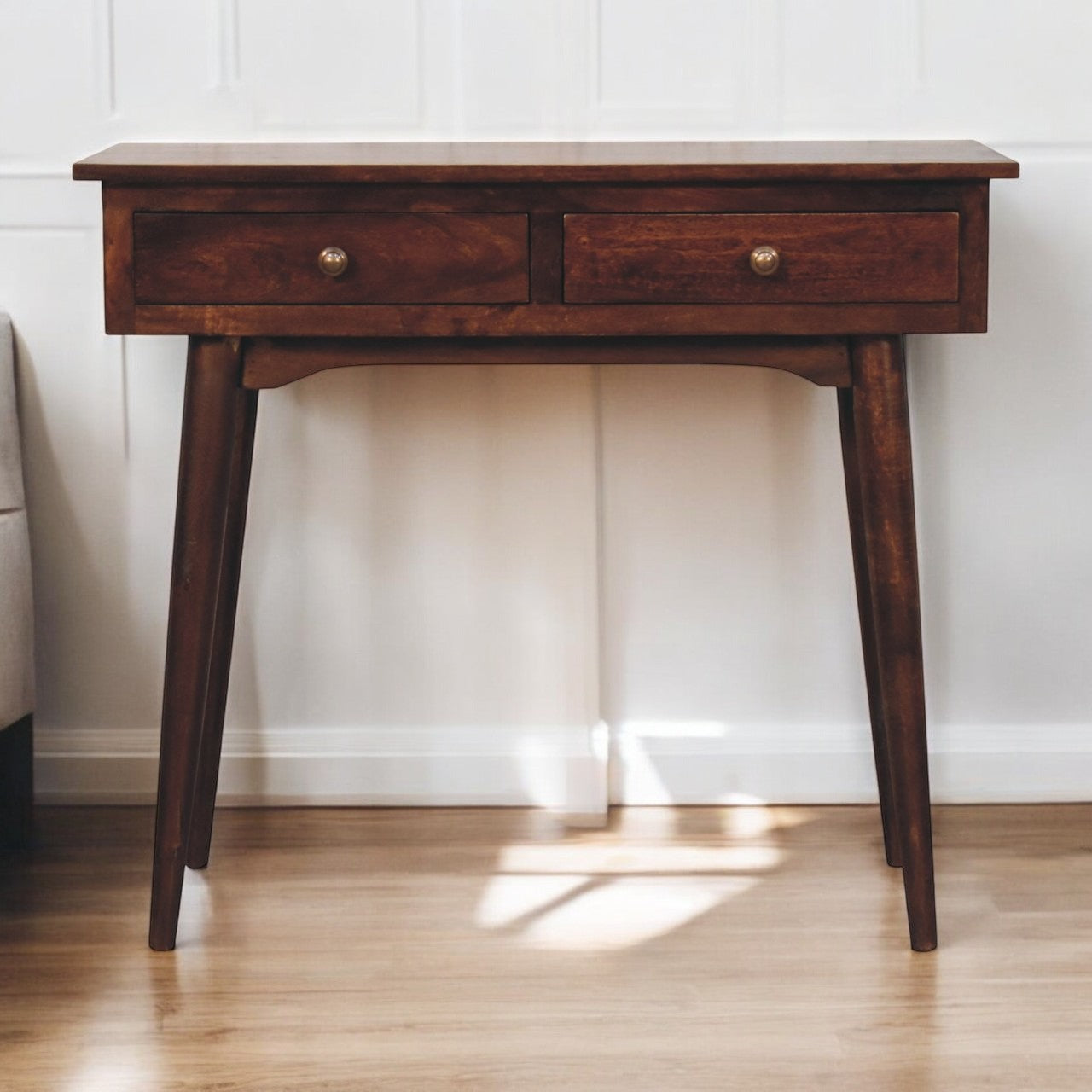 Dark brown walnut console table with two drawers and brass knobs perfect for a hallway or entryway