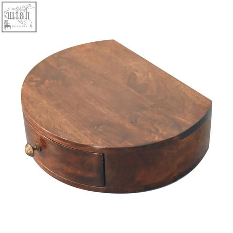 A polished dark brown california walnut wall mounted jewelry box with a curved lid and brass drawer knob