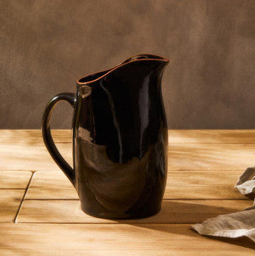 Calisto terracotta black glazed pitcher made of glossy black ceramic with smooth curved handle and spout