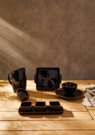 Dark brown ceramic black glazed pitcher with glossy finish and subtle glaze variations in the calisto terracotta set