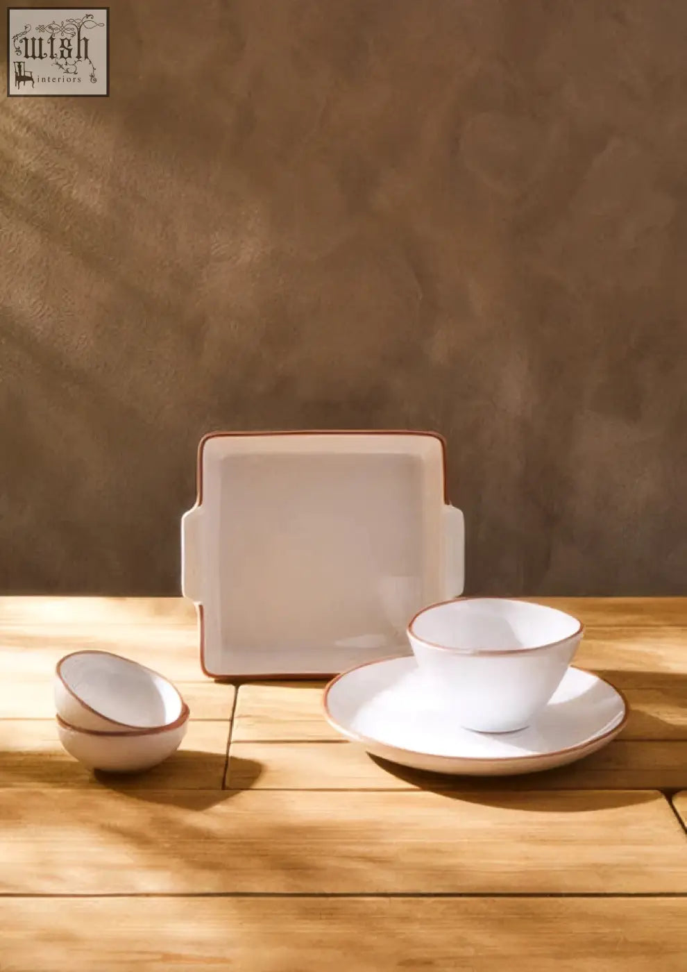 White glazed cereal bowl from calisto terracotta set with subtle gold rims and square rectangular serving pieces