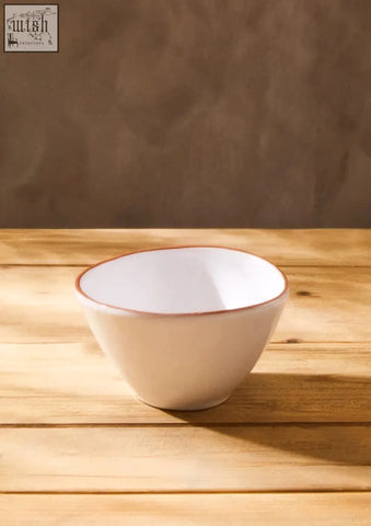 Cream-colored ceramic calisto terracotta white glazed cereal bowl with subtle brown rim for everyday use