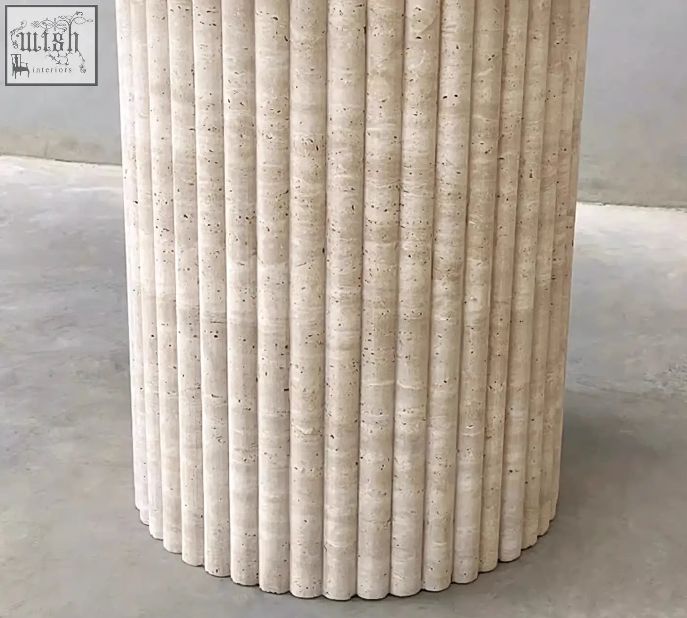 Beige stone pedestal with vertical fluted grooves and speckled texture on callista round dining table marble
