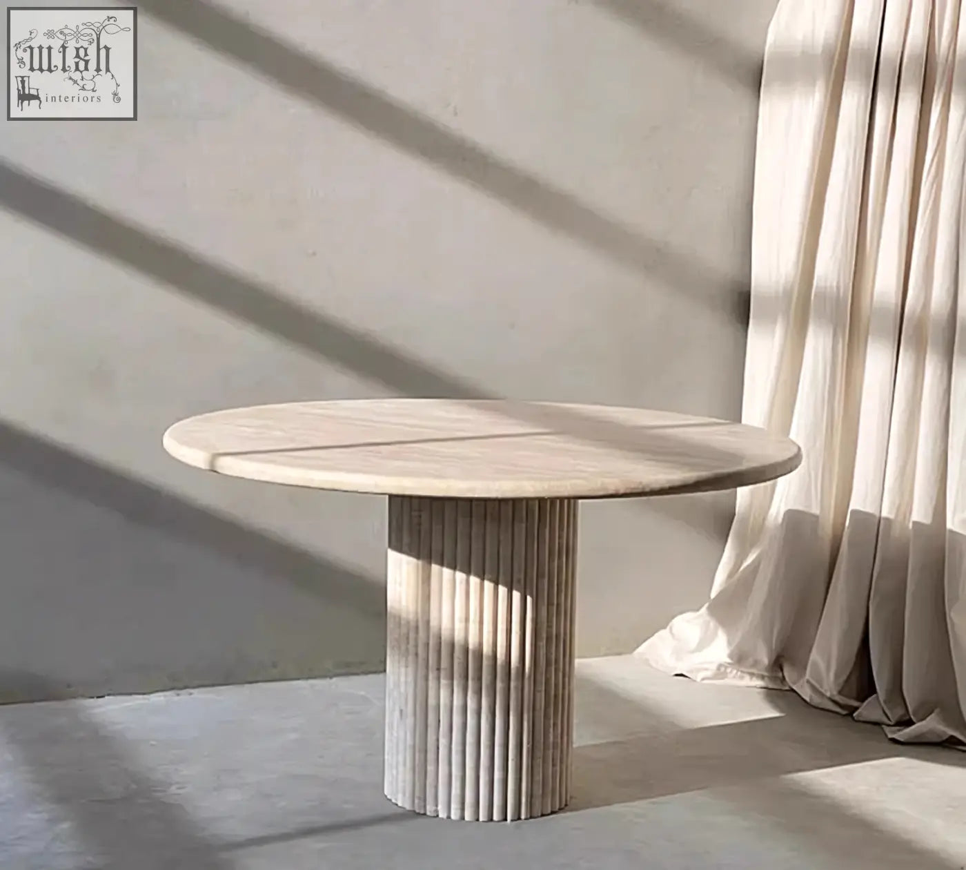 Callista round dining table with a smooth light beige marble top and fluted base perfect for round dining