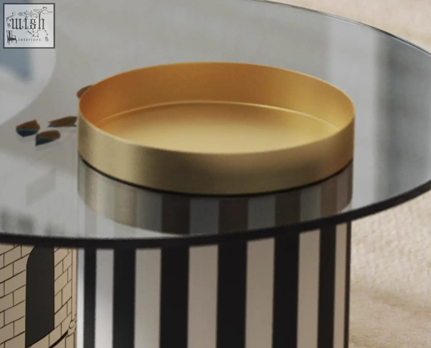 Gold-colored circular tray with smooth metallic finish on glass table from calloway nesting coffee table set