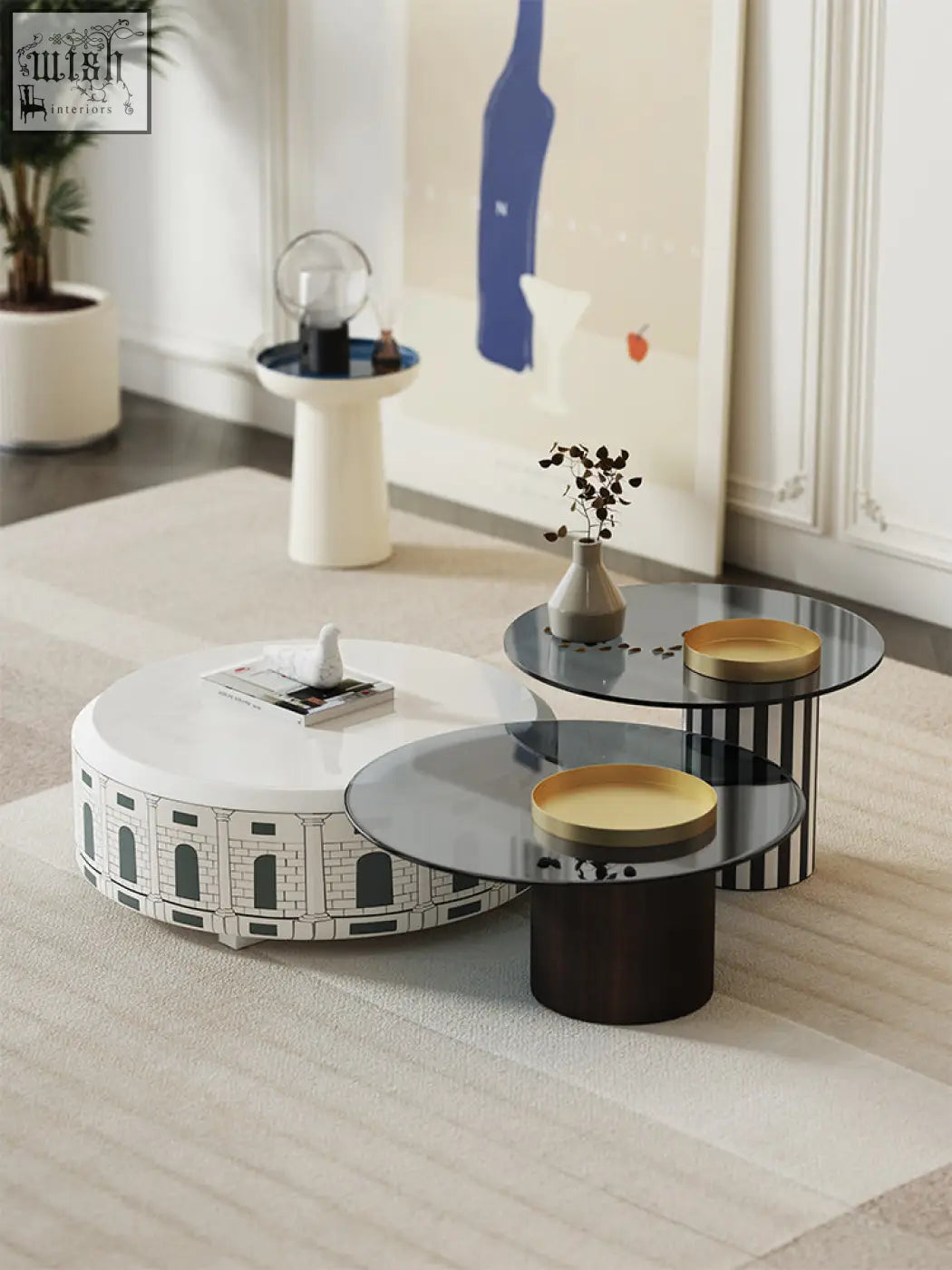 Calloway nesting coffee table set features three modern white and black tables with glass tops and a gold-trimmed tray