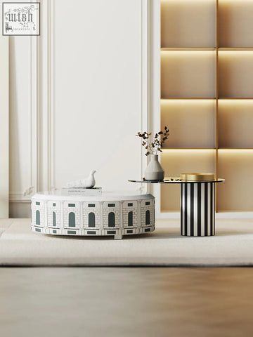 White nesting coffee table set with three tables designed like the colosseum featuring black architectural details
