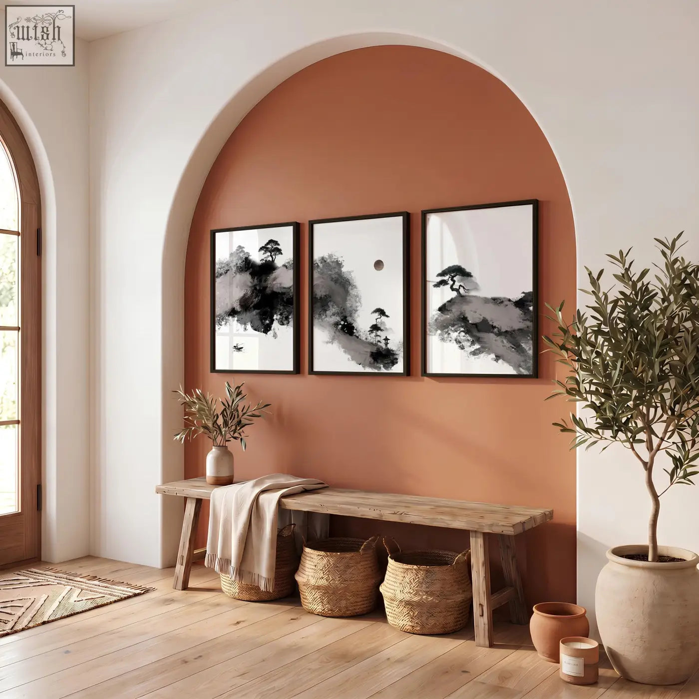 Three framed black and white calming wall art ink wash prints with maroon sun and pine trees on terracotta wall