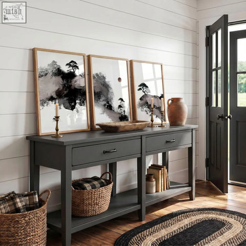 Dark gray console table with two drawers and rustic wooden top displayed below calming wall art japanese ink landscape set