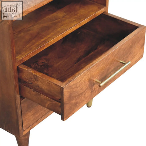 A camden chestnut bedside table made of natural mango wood with warm brown tones and brass handles featuring one drawer