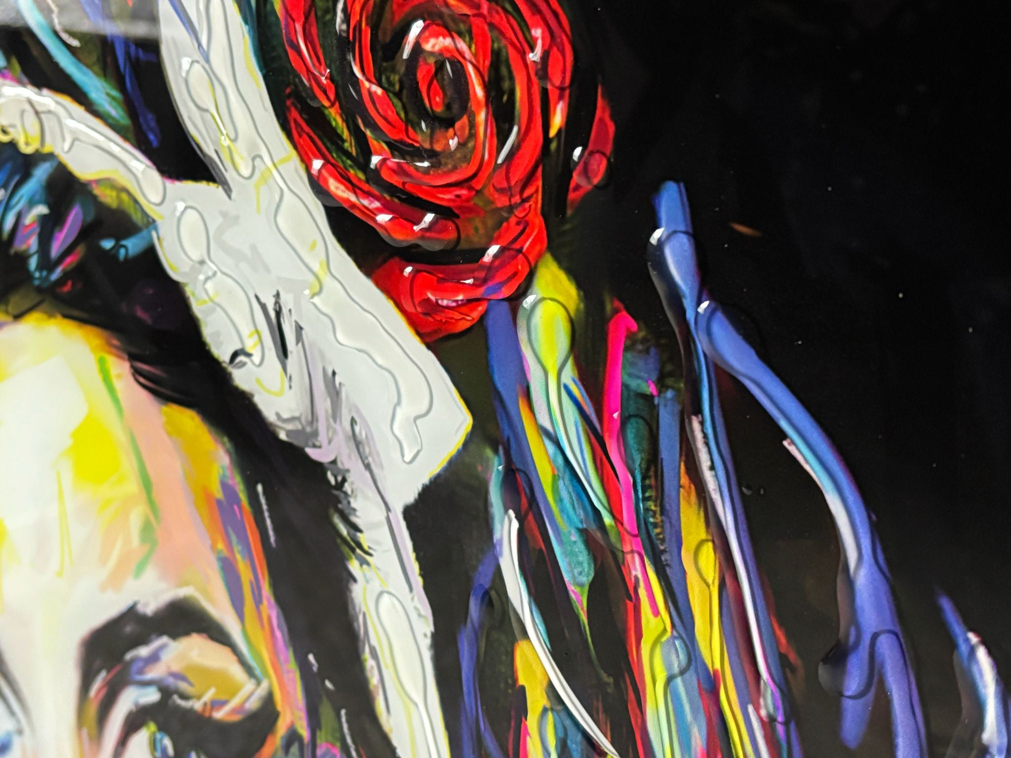 A vibrant liquid art painting called camden’s angel featuring a bold red rose with swirling black and white accents