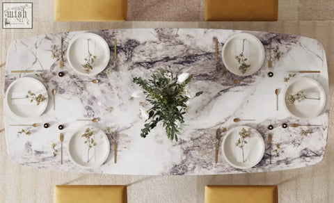 A long rectangular cameron marble dining table with a white and gray veined marble dining table surface