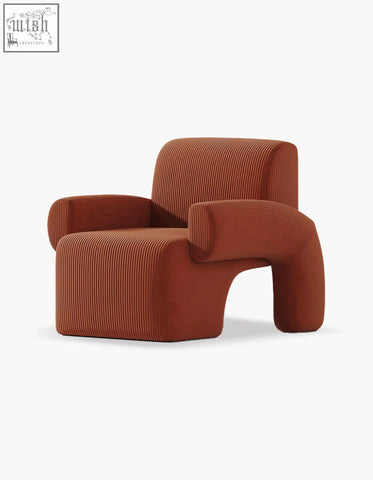 Camilla armchair with rich terracotta corduroy upholstery and deep seat featuring ribbed texture and organic lines