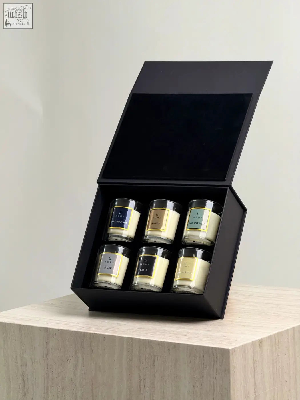 Black gift box candle discovery set with six glass candle jars featuring minimalist labels for easy scent discovery